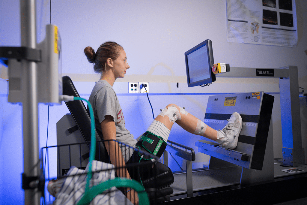 Athlete sitting in a performance tracking machine looking at an output screen