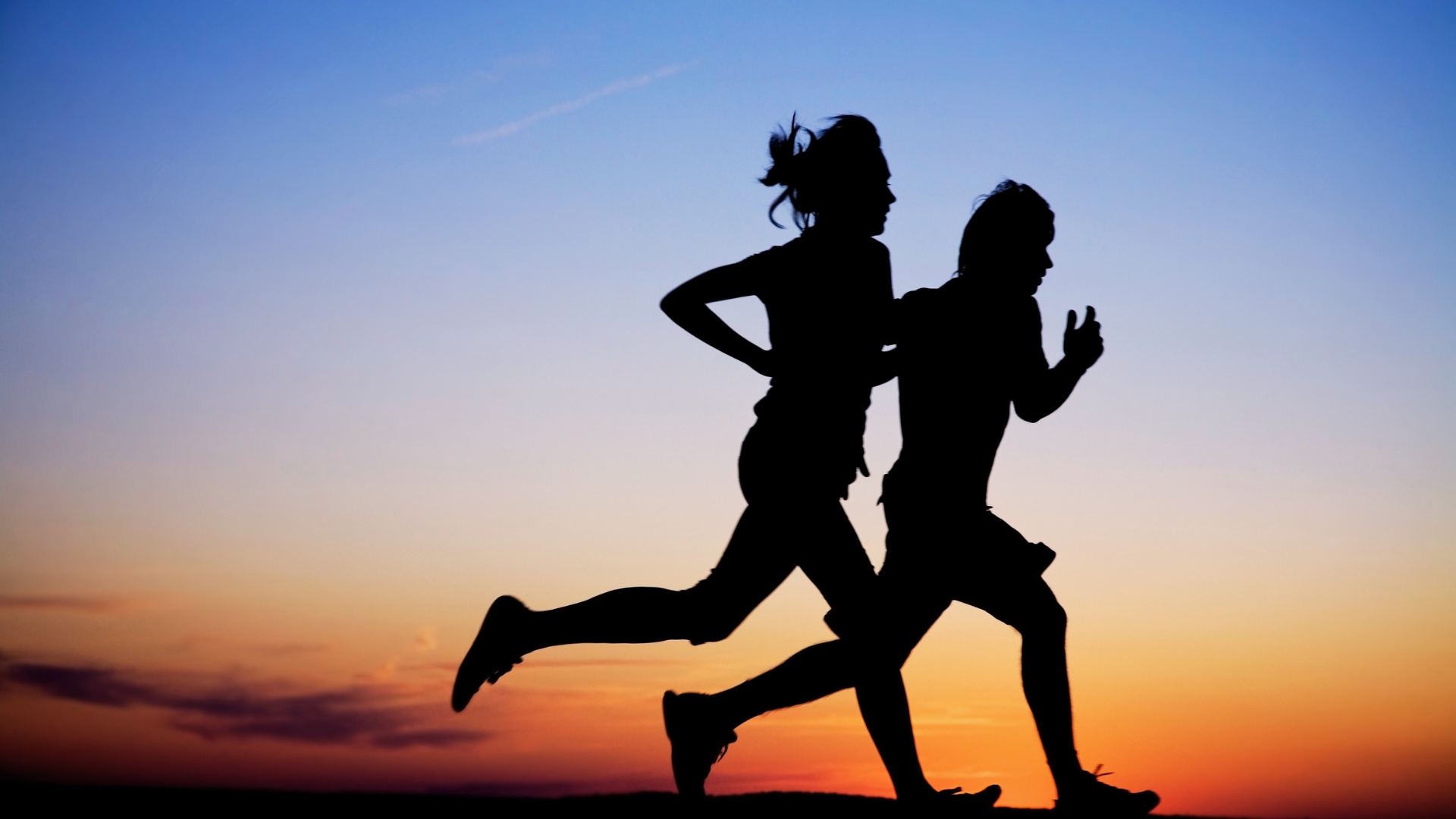 Silhouette of two runners