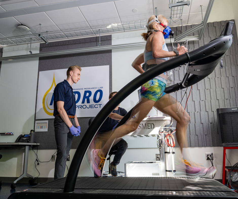Athlete running on the treadmill while technicians observe
