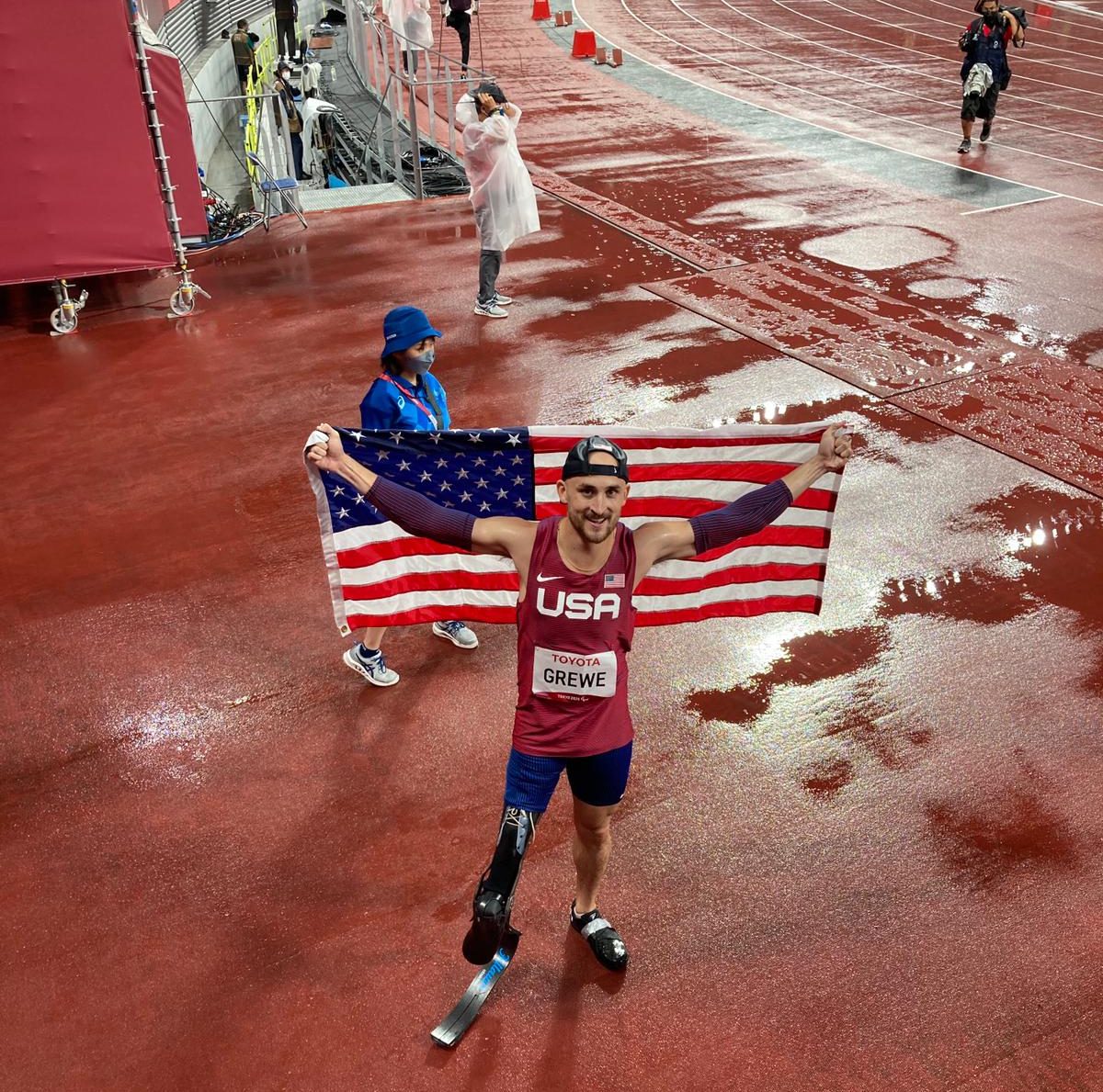 Paralympic athlete holding the American flag